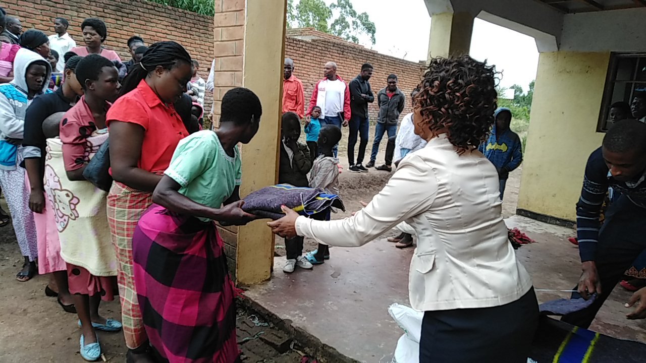 People greet one another outside a building.